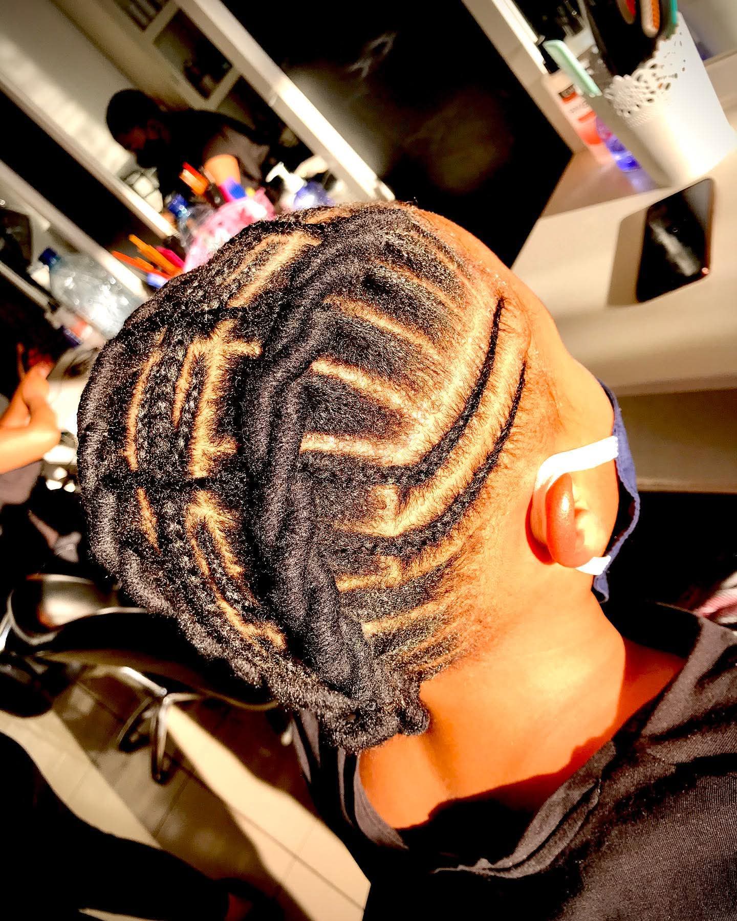 Intricate cornrow patterns with honey blonde highlights